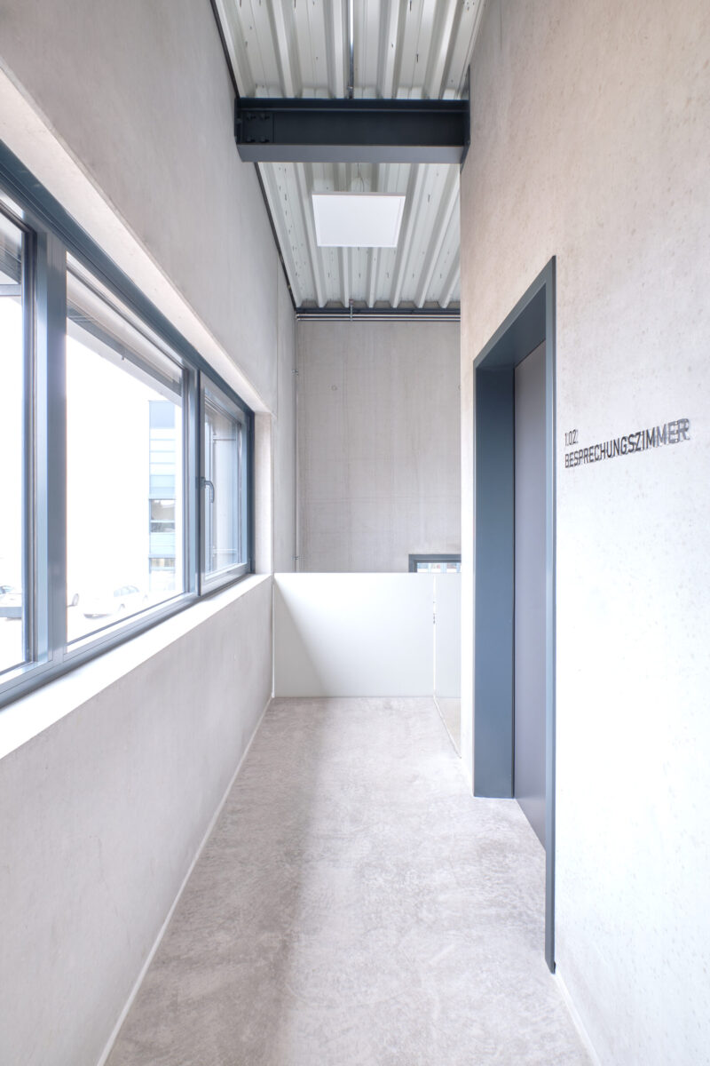 geha tech neuhausen – innenansicht flur mit fenstern heller flur mit fenstern und sichtbetonwänden